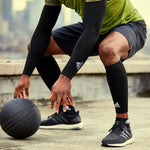Stong male uses adidas compression sleeves throughout workout to stimulation blood circulation and boost performance.