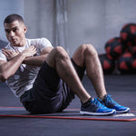 Male doing sit ups on adidas TRAINING MAT in gym. 